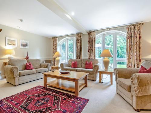 a living room with couches and a table at Coach House - Uk49887 in Preston