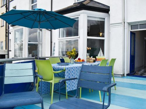 a table with chairs and an umbrella on a patio at Fronks House in Harwich