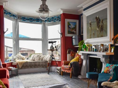 a living room with a couch and a fireplace at Fronks House in Harwich