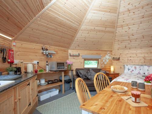 a kitchen and living room of a log cabin at Coot Roundhouse - Uk33890 in Cullompton