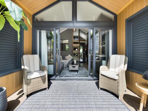 a room with two chairs and a room with a bed at Aqueduct Hideaway in Llangollen