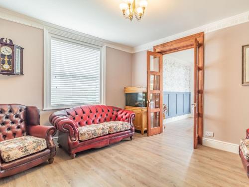 a living room with two chairs and a couch at Riversdelle in Beccles