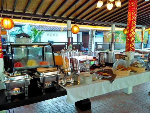 a buffet line with a table with food on it at Absolute Scuba Bali Dive Resort in Padangbai