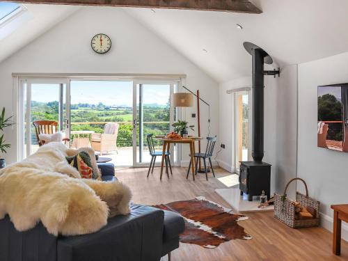 a living room with a dog laying on a couch at Ty Twm in Criccieth