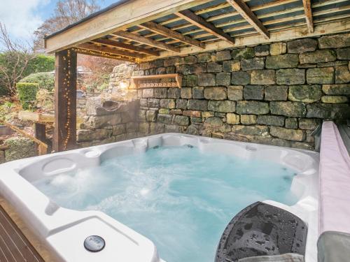 a jacuzzi tub in a stone wall at Hob Cote - Cottage in Heptonstall