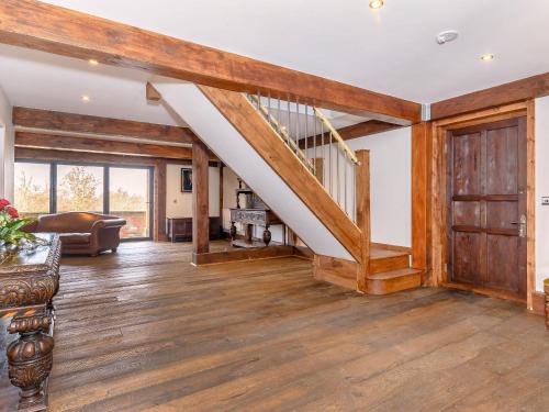 a living room with wooden floors and a staircase at Olive Lodge in Melbourne
