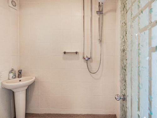a bathroom with a sink and a shower at Seacroft Lodge in Skegness