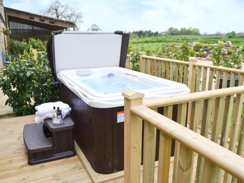 a barbecue on a deck with a sink at Sykelands Cottage in Ravensworth