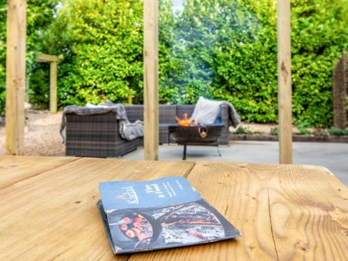 a book sitting on top of a wooden table at Old Shires Barn in Norton