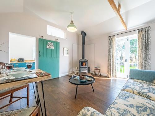 a kitchen and living room with a stove at The Cowshed - Uk50803 in Cratfield