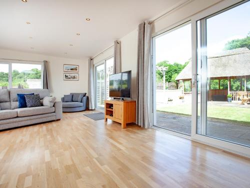 a living room with a television and a couch at Sundance in Cheriton Bishop