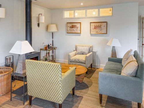 a living room with a table and chairs at Cairn Ryan in Saint Mawes