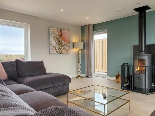 a living room with a couch and a fireplace at The Elms - Ukc4613 in Dunholme