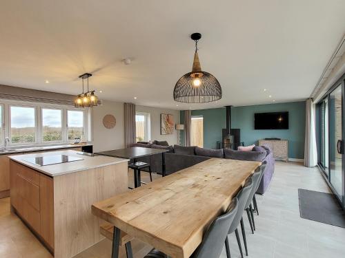 a kitchen and living room with a wooden table at The Elms - Ukc4613 in Dunholme