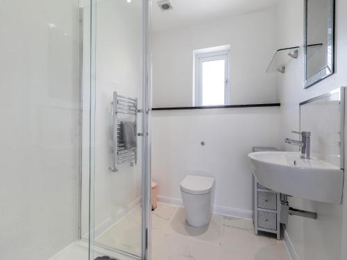 a bathroom with a toilet and a sink and a shower at The Old School House in Barnsley