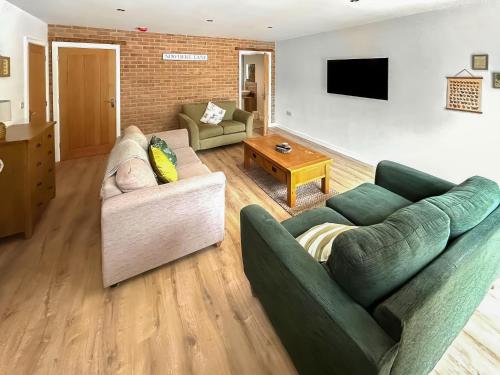a living room with two couches and a tv at No 4 Squirrels Nest-Uk44305 in Lenwade