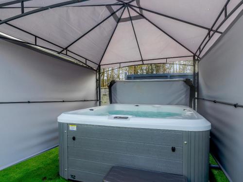 a hot tub in a tent with green grass at Fairview in Penicuik