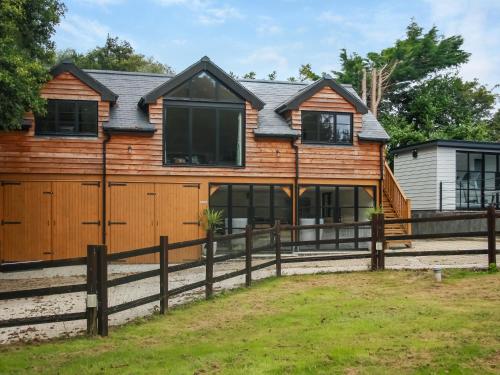 a wooden house with a fence at Foxton Barn - Uk47297 in Harrietsham