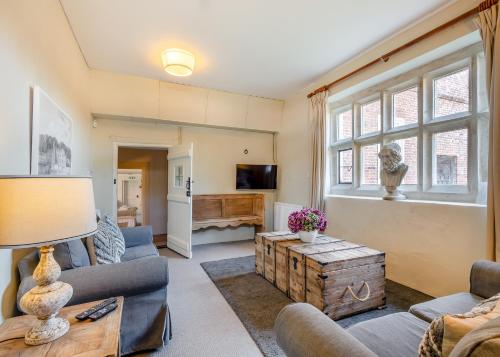a living room with couches and a table at Oxnead Hall in Brampton