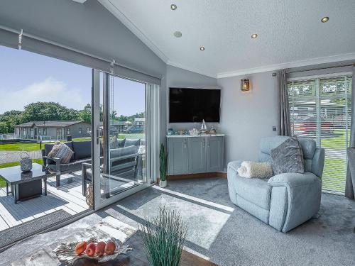 a living room with a couch and a tv at 36 At The Sanctuary - Uk50278 in Carnguwch