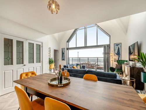 a living room with a table and a couch at Sandbanks in Bridlington