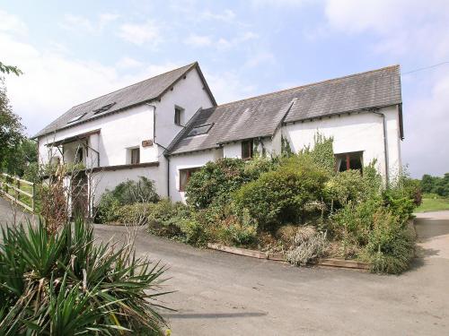 a white house with a gray roof at Discovery in Cheriton Bishop