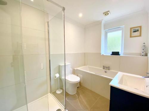 a bathroom with a shower and a toilet and a sink at Seagrass in Lamlash
