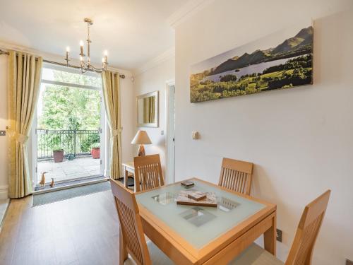 a dining room with a table and chairs and a window at Apartment 14, Hazelwood Hall in Silverdale