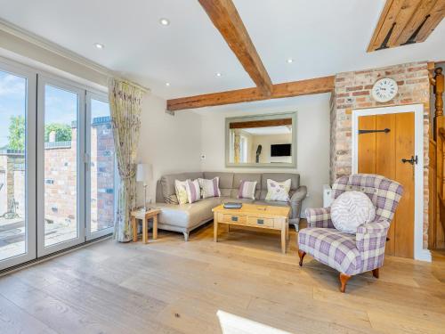 a living room with a couch and a table at The Rose- Uk47155 in Burgh le Marsh