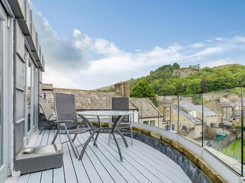 a balcony with a table and chairs on a building at Cragdale Penthouse in Settle
