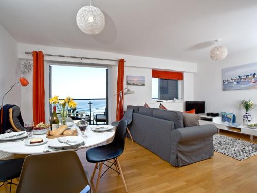 a living room with a couch and a table at 42 Ocean 1 in Crantock