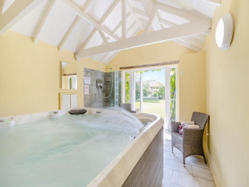a large bathroom with a large soaking tub at The Farmhouse- Uk47148 in Burgh le Marsh