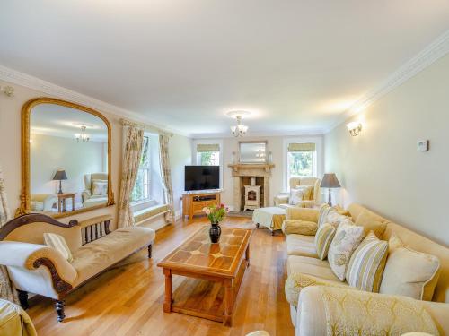 a large living room with couches and a fireplace at The Farmhouse- Uk47148 in Burgh le Marsh