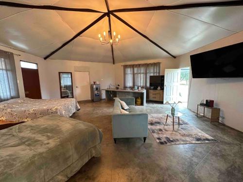 a bedroom with two beds and a flat screen tv at MERs house enjoys nature in Cajamarca
