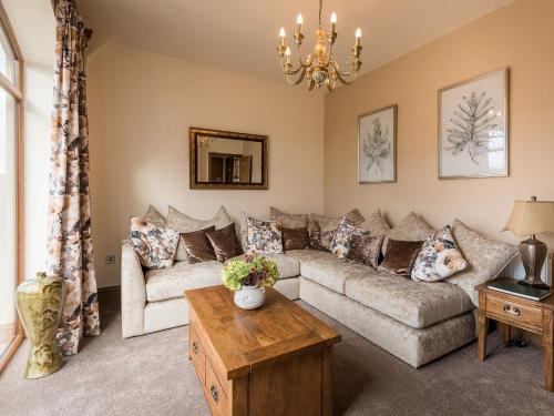 a living room with a couch and a table at Cedar Barn - Uk33352 in Buttershaw