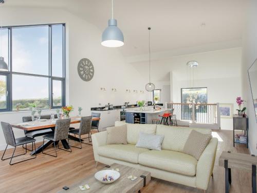 a living room with a couch and a table at Foxglove-Uk34612 in Nether Stowey