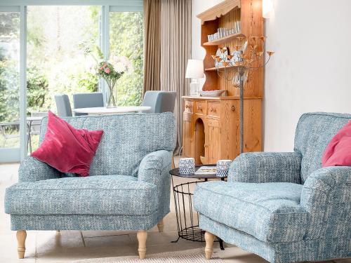 a living room with two chairs and a table at The Hall - Uk32690 in Horton