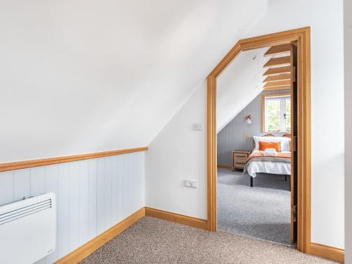 a hallway with a mirror and a bed in a room at Silhouette's Stable - Uk34102 in Chichester