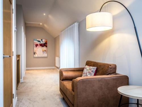 a living room with a couch and a table at The Hazels - Ukc4614 in Dunholme