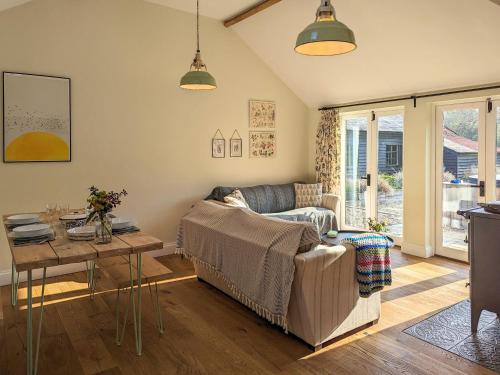 a living room with a couch and a table at The Stables - Uk50804 in Halesworth
