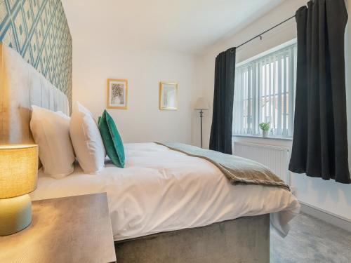 a bedroom with a large bed and a window at Sandcastles in Bridlington