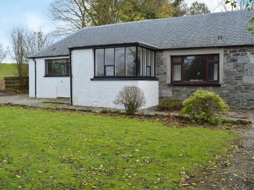 a white house with black windows and a yard at West Lodge - Uk7137 in Newton Stewart