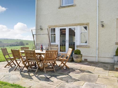 a patio with a table and chairs in front of a house at Yonderton House - Uk11181 in Hollybush