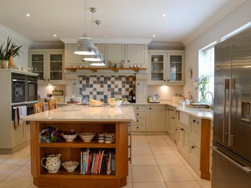 a kitchen with white cabinets and a large island at Yonderton House - Uk11181 in Hollybush