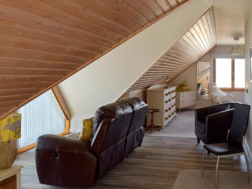a living room with a couch and two chairs at Seal Rocks in Lendalfoot