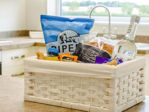 a basket filled with food and a bottle of wine at Henrys Retreat in Ingoldsby