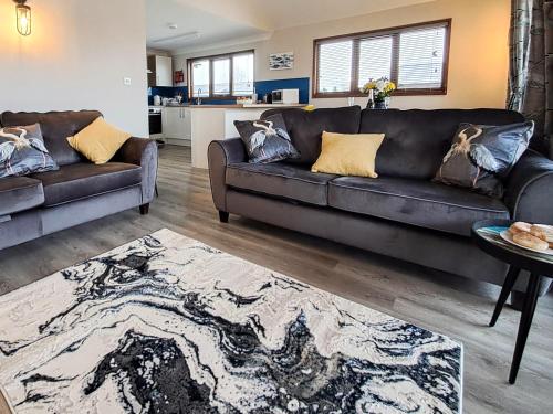 a living room with a couch and a table at River Breeze-B6853 in Brundall