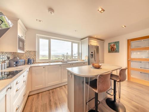 a kitchen with a island with a table in it at Wynmine Cottage in Esh