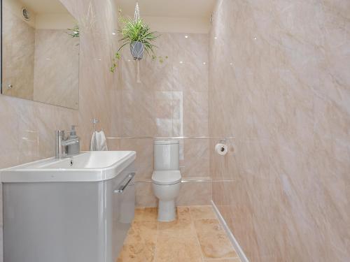 a bathroom with a white toilet and a sink at Old Barn 1 - Uk48477 in Ferndown