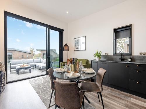 a kitchen and dining room with a table and chairs at Cadnant Lodge 2 - Uk42795 in Llangefni
